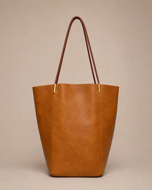 Margot Tote in brown genuine leather featuring a clean vertical silhouette, slim shoulder straps and timeless everyday elegance.