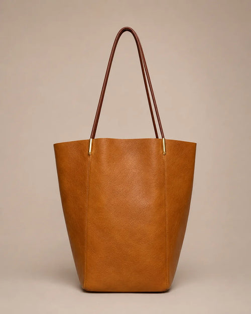 Margot Tote in brown genuine leather featuring a clean vertical silhouette, slim shoulder straps and timeless everyday elegance.