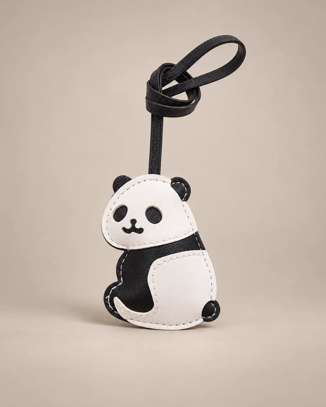Panda bag charm in black and white PU leather with a black hanging strap, by Malena London