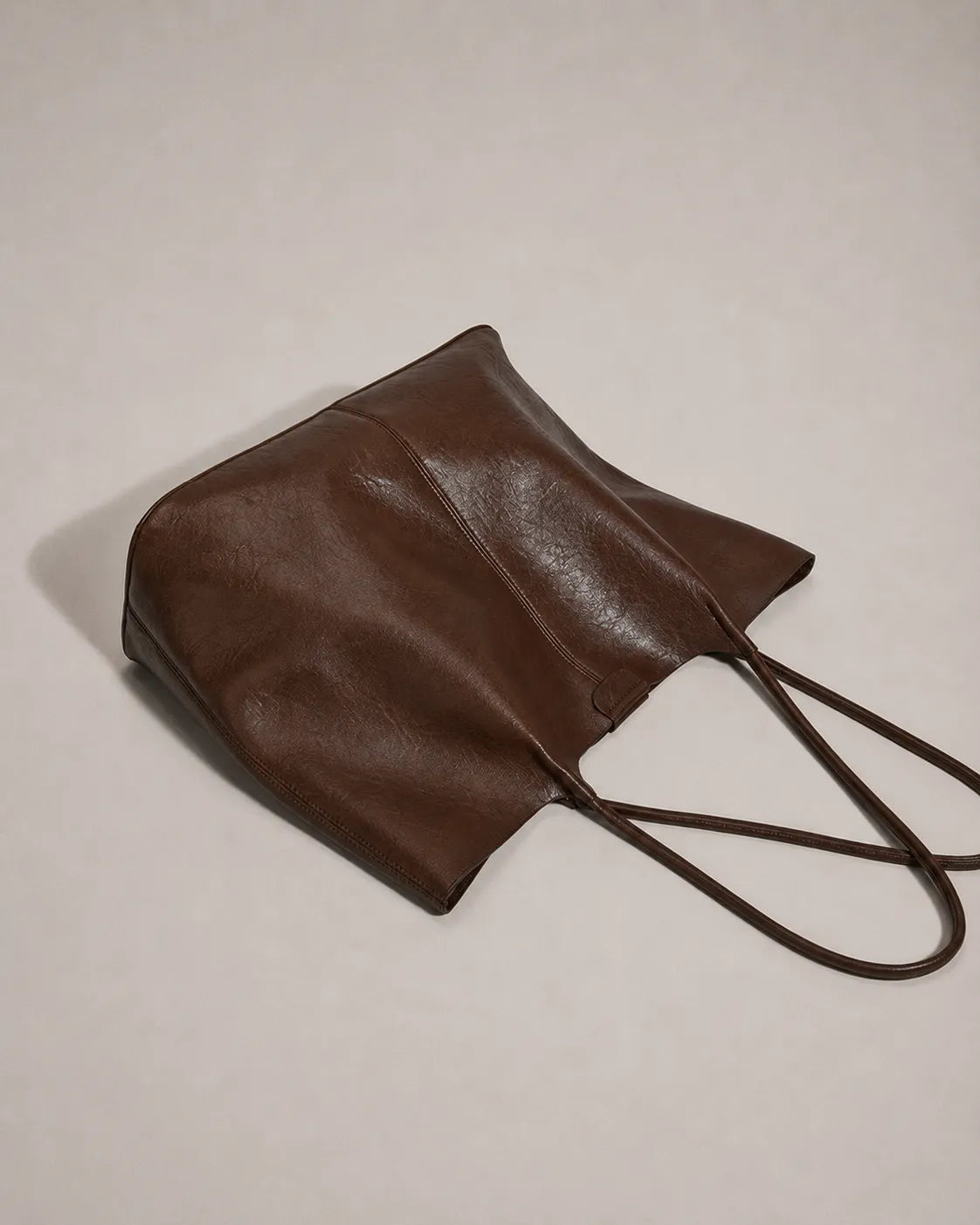 Back view of the Valentina Tote in dark chocolate leather showcasing its soft structure, clean lines and spacious tote silhouette.