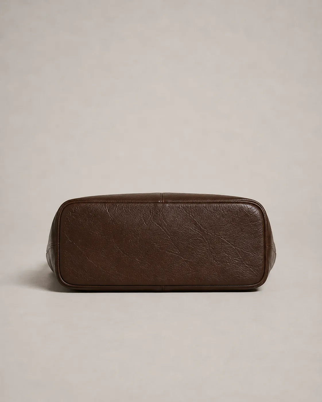 Bottom view of the Valentina Tote in dark chocolate leather showing the structured base and spacious tote construction.