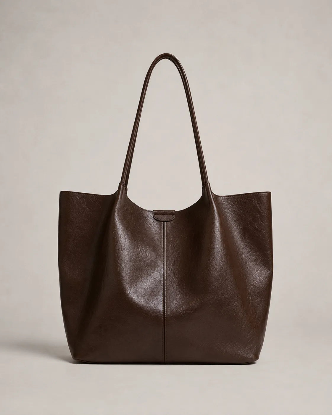 Front view of the Valentina Tote crafted from soft dark chocolate leather with a spacious silhouette and minimalist design.