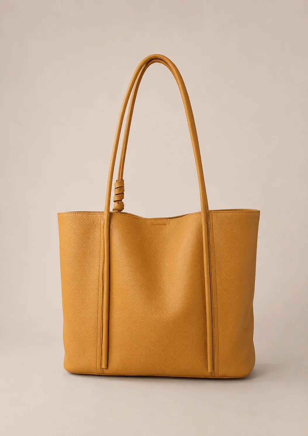 Back view of the Vivienne large Togo leather tote bag in biscuit crafted from premium first-layer Togo leather with a clean minimalist silhouette.