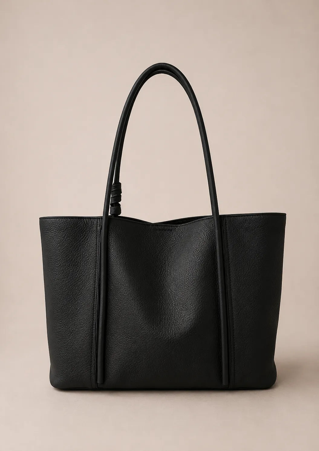 Back view of the Vivienne large Togo leather tote bag in black crafted from premium first-layer Togo leather with a clean minimalist silhouette and double shoulder straps.