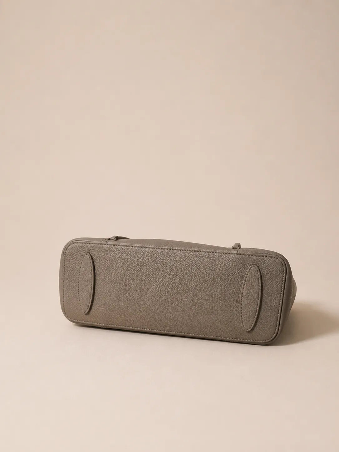 Bottom view of the Vivienne large Togo leather tote bag in elephant grey featuring a structured base and premium Togo leather finish