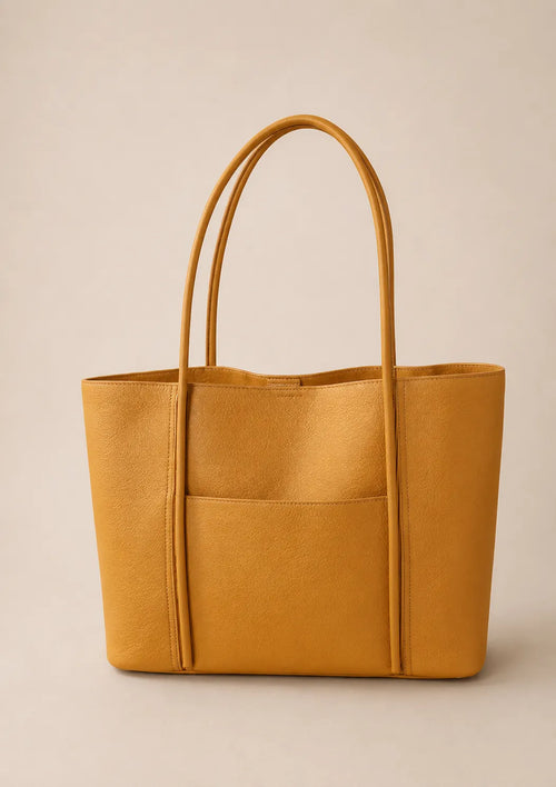 Front view of the Vivienne large Togo leather tote bag in biscuit featuring a spacious design, exterior slip pocket and comfortable shoulder straps.
