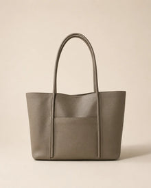 Front view of the Vivienne large Togo leather tote bag in elephant grey with exterior slip pocket and double shoulder straps