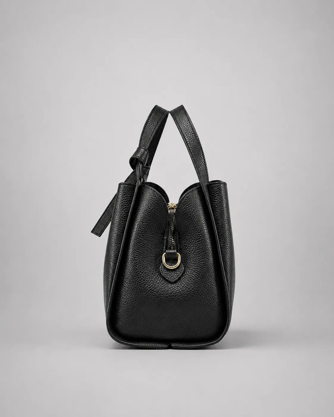 Side profile of the Amelia Leather Tote Bag in Black genuine leather highlighting its spacious silhouette and refined proportions.