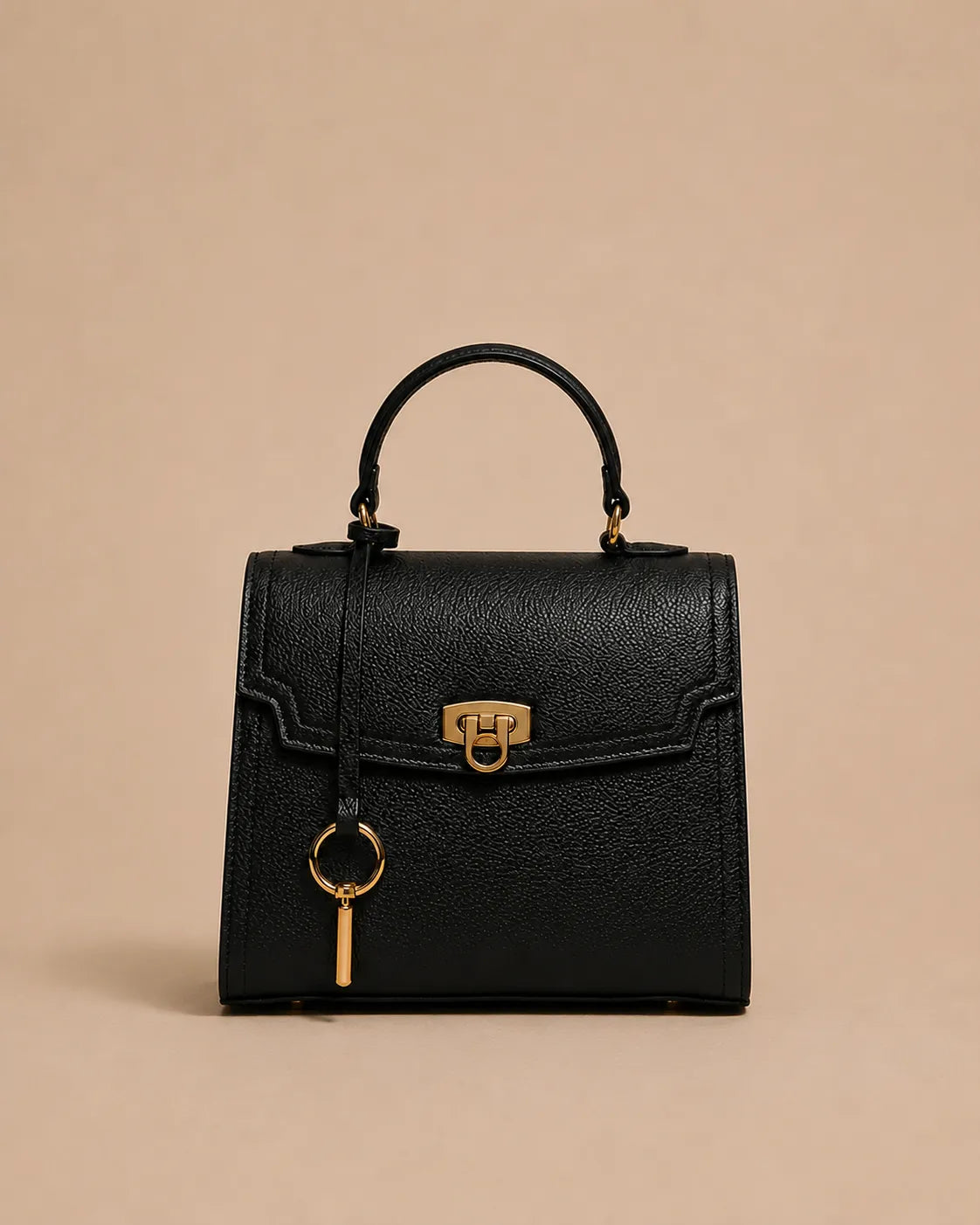 Beatrice genuine leather top handle bag in black featuring structured silhouette, gold-tone hardware, front lock closure and detachable shoulder strap. The Essentials Collection by Malena London.