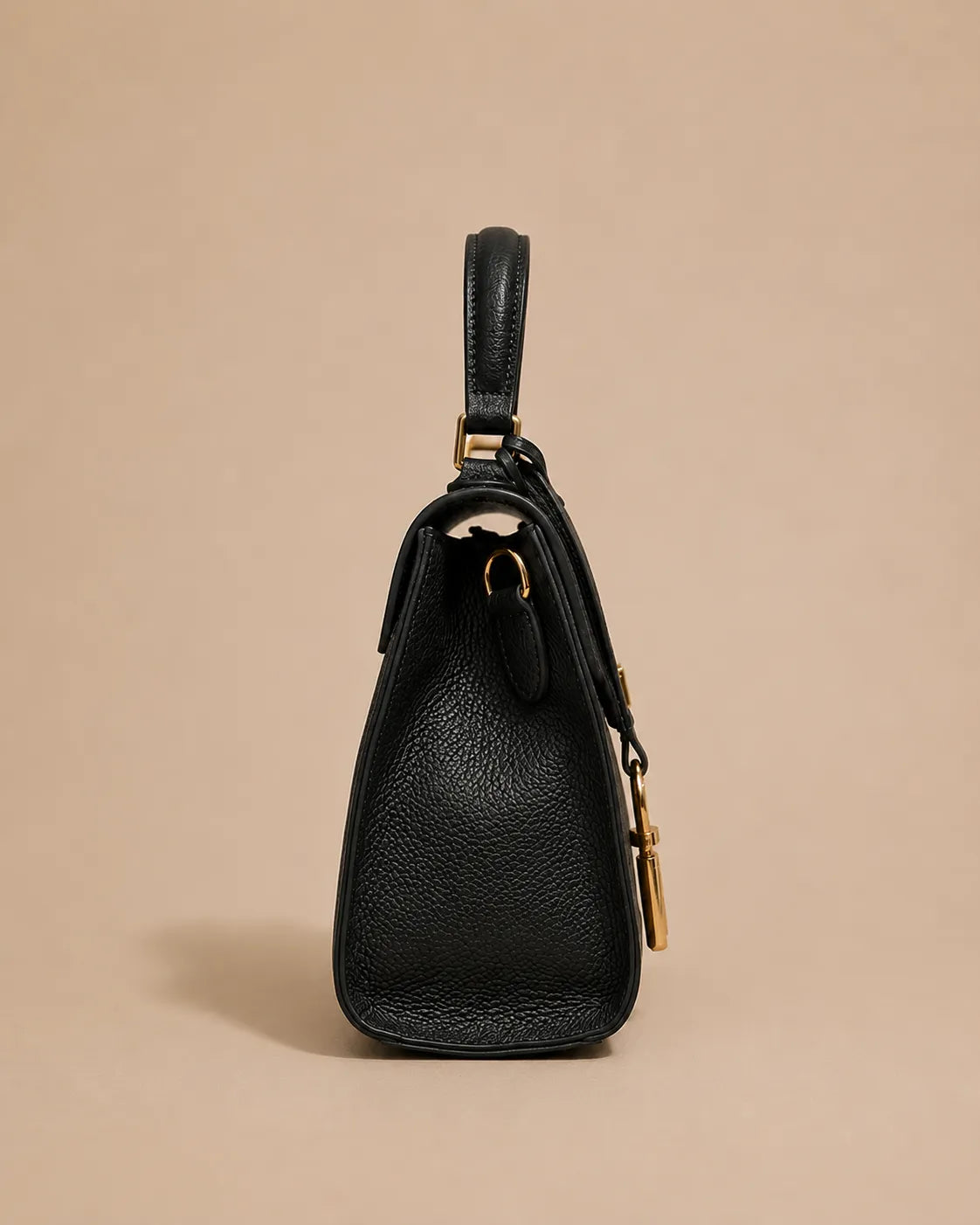 Side profile of the Beatrice genuine leather top handle bag in black featuring a structured silhouette, compact depth and elegant top handle design.
