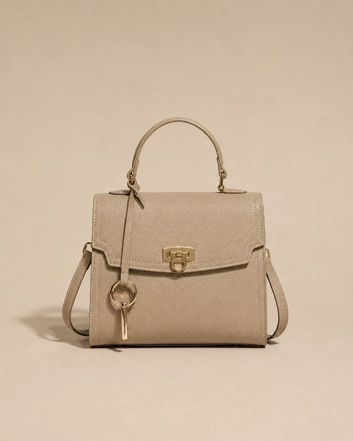 Beatrice genuine leather top handle bag in elephant gray featuring a structured silhouette, gold-tone lock closure, top handle and detachable shoulder strap. The Essentials Collection by Malena London.