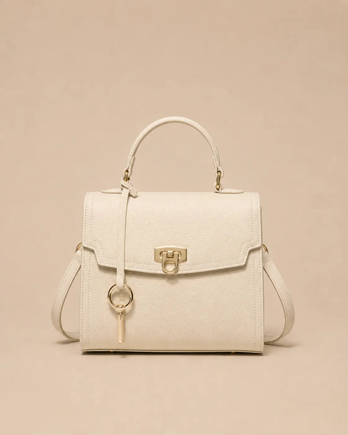 Beatrice genuine leather top handle bag in rice white featuring a structured silhouette, premium pebbled leather, gold-tone lock closure and detachable shoulder strap. The Essentials Collection by Malena London.
