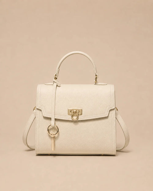 Beatrice genuine leather top handle bag in rice white featuring a structured silhouette, premium pebbled leather, gold-tone lock closure and detachable shoulder strap. The Essentials Collection by Malena London.