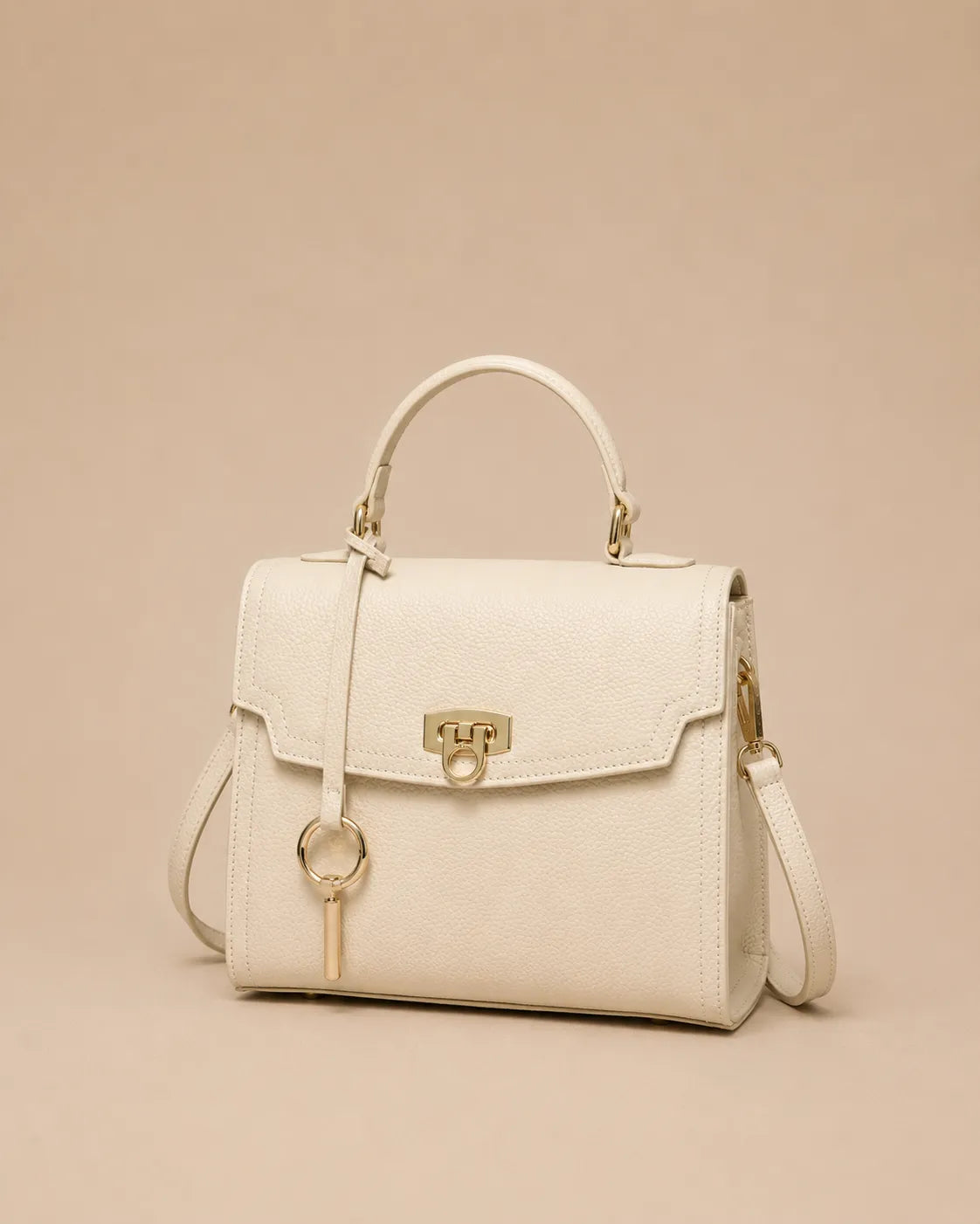 Beatrice genuine leather top handle bag in rice white featuring a structured silhouette, gold-tone hardware, detachable shoulder strap and elegant three-quarter front view. The Essentials Collection by Malena London.