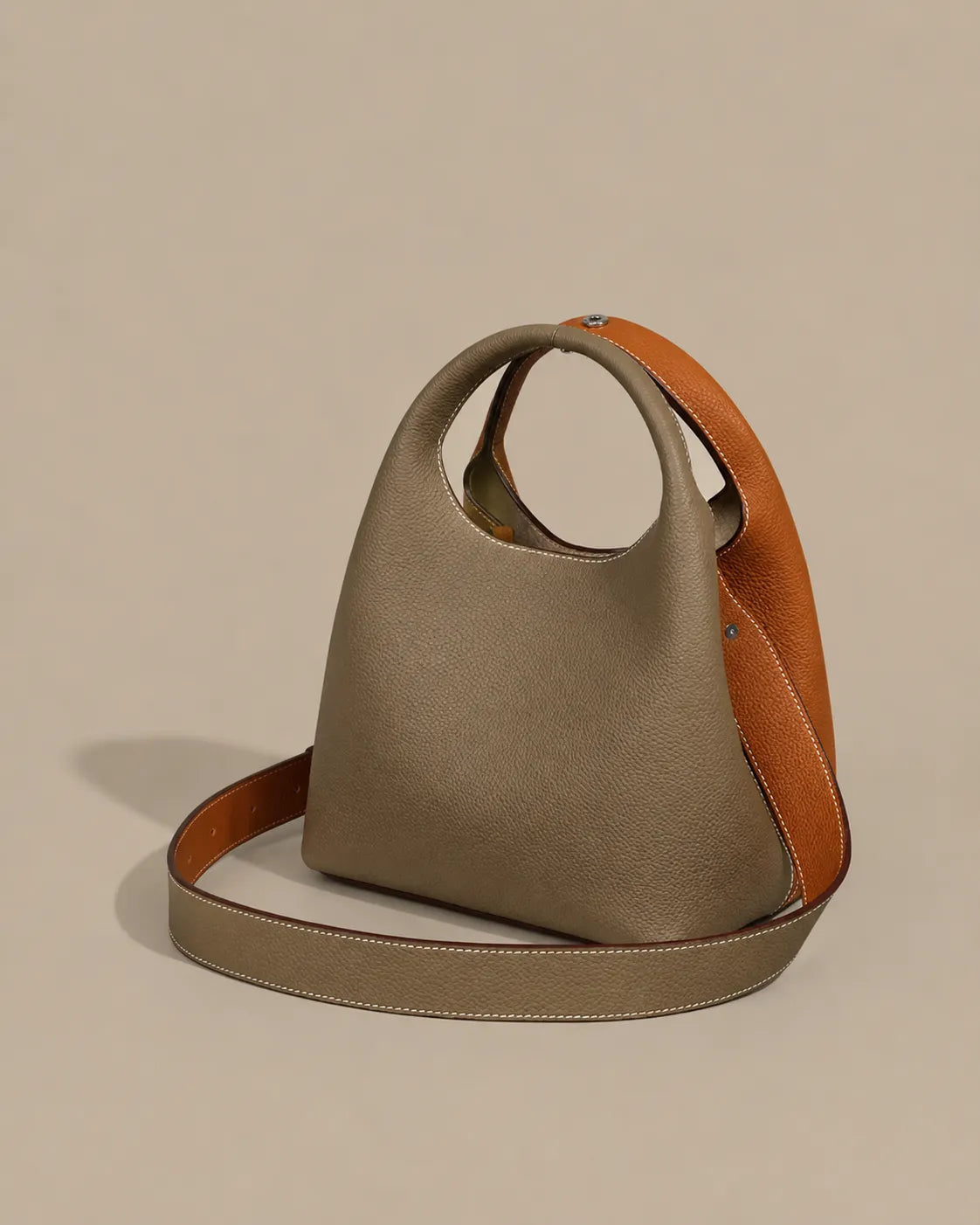 Rear view of the Camille leather bucket bag showcasing its sculptural silhouette and adjustable leather strap.