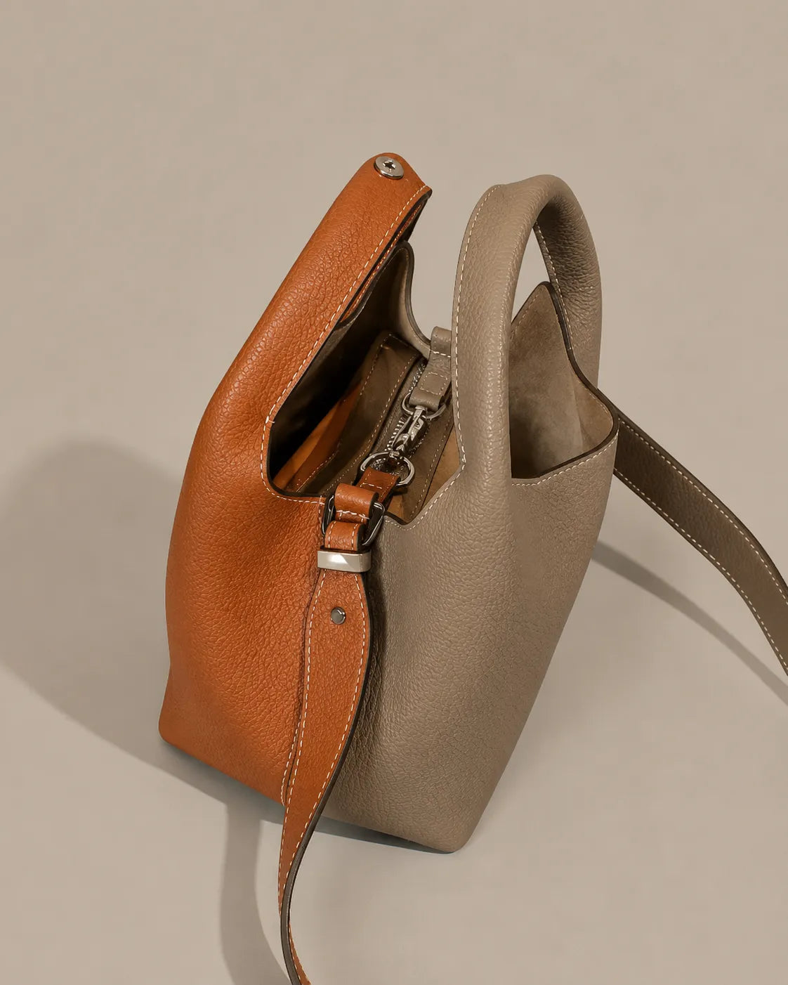 Interior detail of the Camille leather bucket bag featuring a spacious compartment and laminated zip pocket.