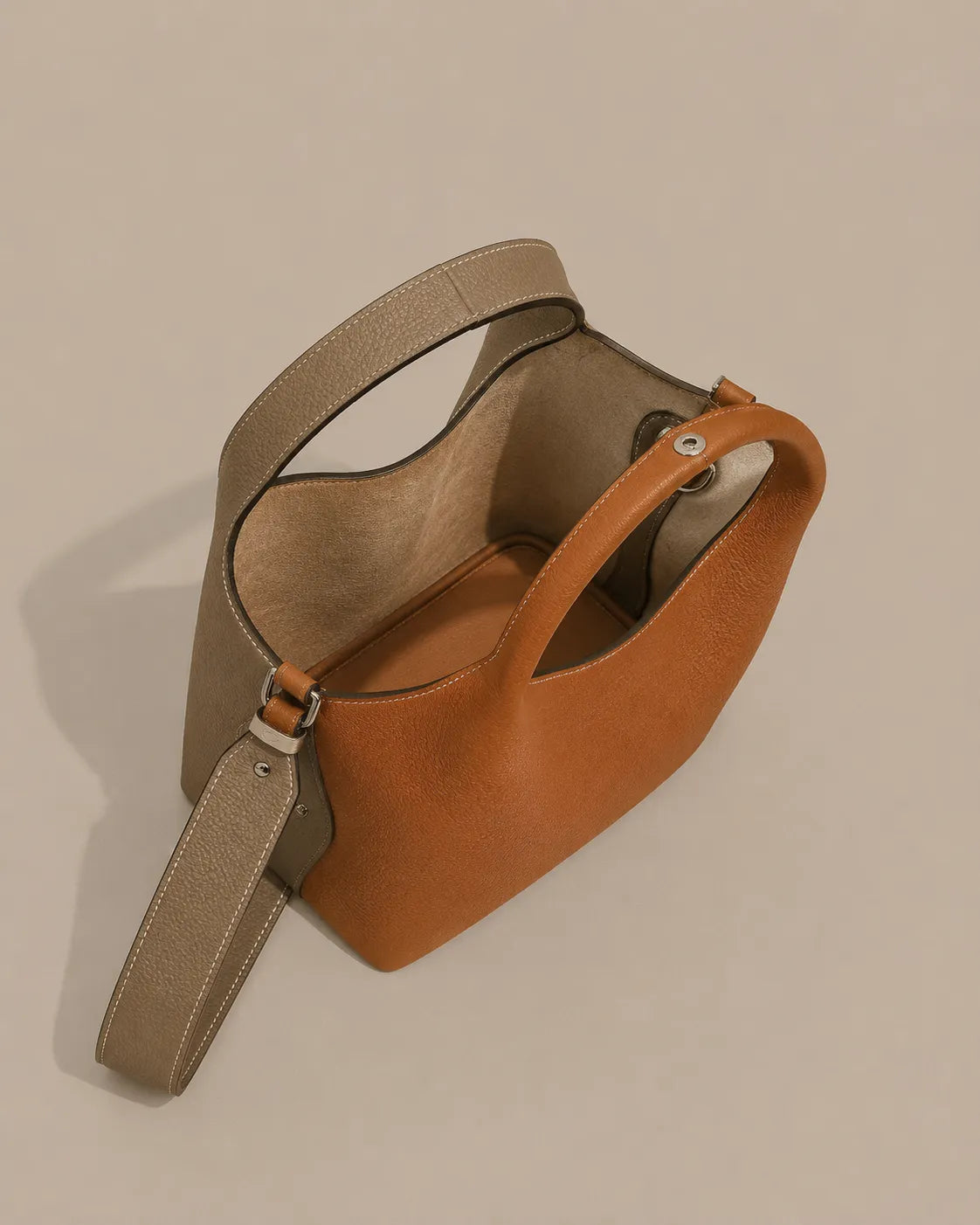 Top view of the Camille leather bucket bag highlighting its spacious interior and sculptural handle design.