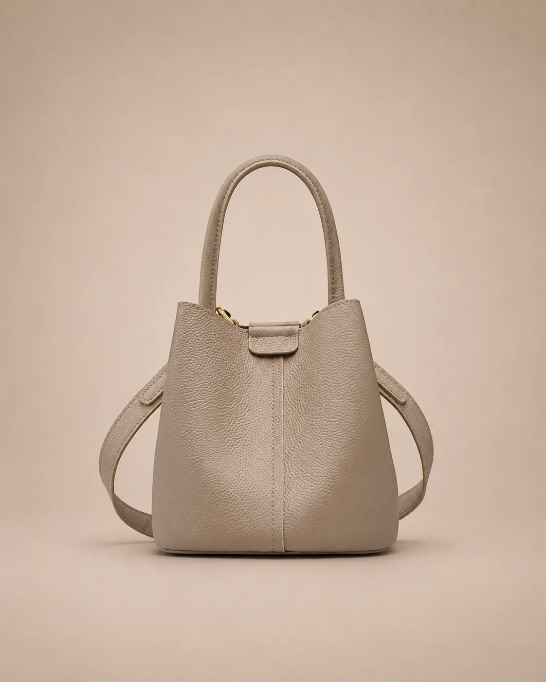 Charlotte genuine leather bucket bag in elephant gray featuring a structured silhouette, top handle and adjustable crossbody strap.