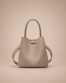 Charlotte genuine leather bucket bag in elephant gray featuring a structured silhouette, top handle and adjustable crossbody strap.