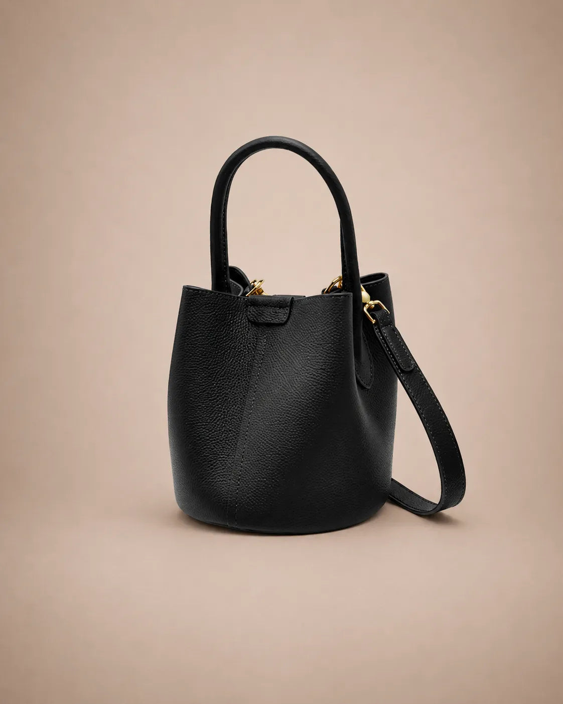 Side angle view of the Charlotte leather bucket bag in black highlighting its elegant bucket shape and premium leather texture.