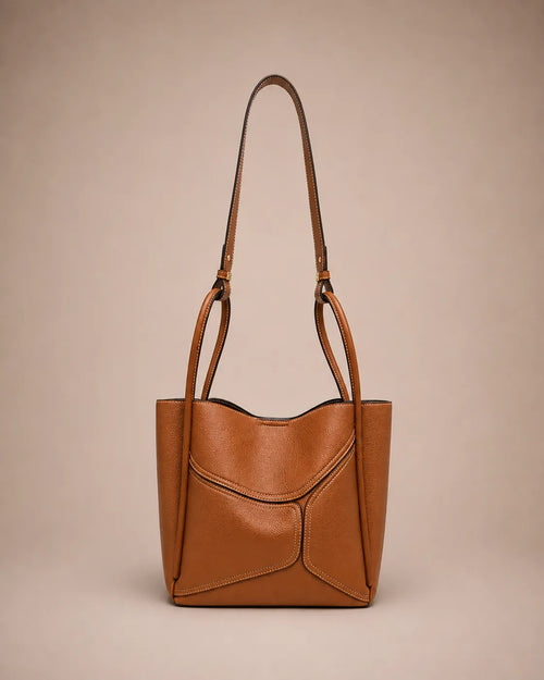 Delphine Leather Shoulder Bag in Cookie genuine leather featuring an architectural front panel design, structured silhouette, top handles and removable shoulder strap. A statement leather handbag by Malena London.