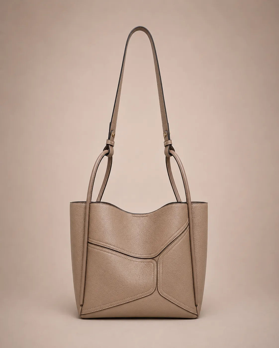 Delphine Leather Shoulder Bag in Elephant Gray genuine leather featuring an architectural front panel design, structured silhouette, top handles and removable 60 cm shoulder strap. A modern statement handbag by Malena London.