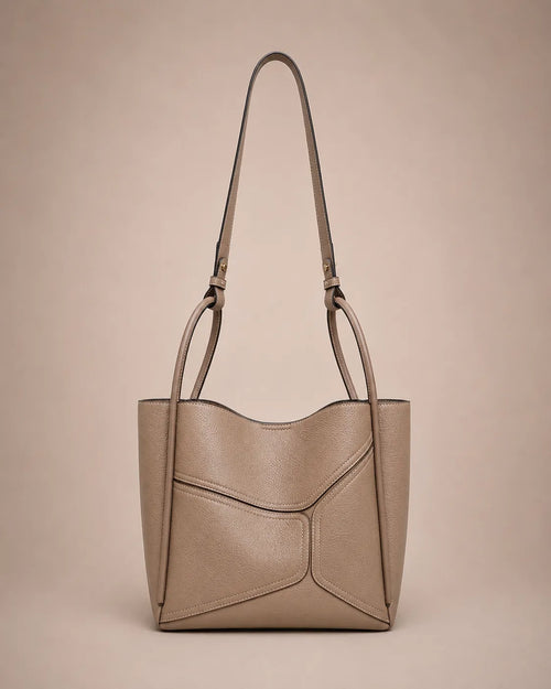 Delphine Leather Shoulder Bag in Elephant Gray genuine leather featuring an architectural front panel design, structured silhouette, top handles and removable 60 cm shoulder strap. A modern statement handbag by Malena London.