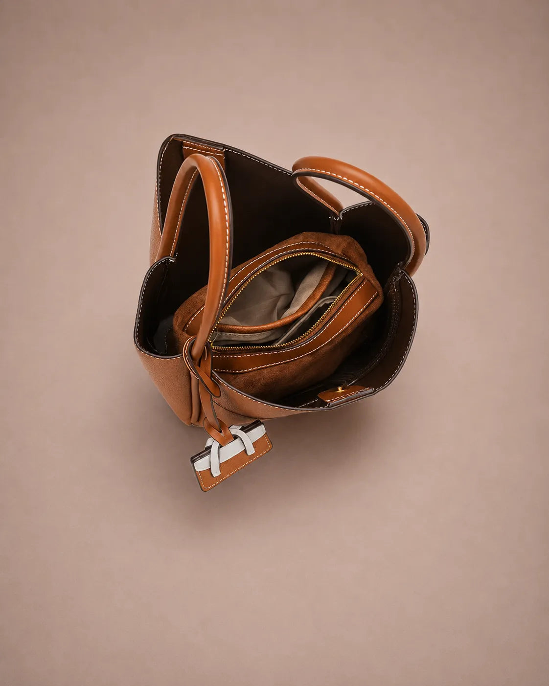 Interior view of the Delphine Leather Shoulder Bag in Cookie genuine leather featuring a spacious compartment layout, central zip pocket, organized storage sections and premium interior finish designed for everyday functionality.