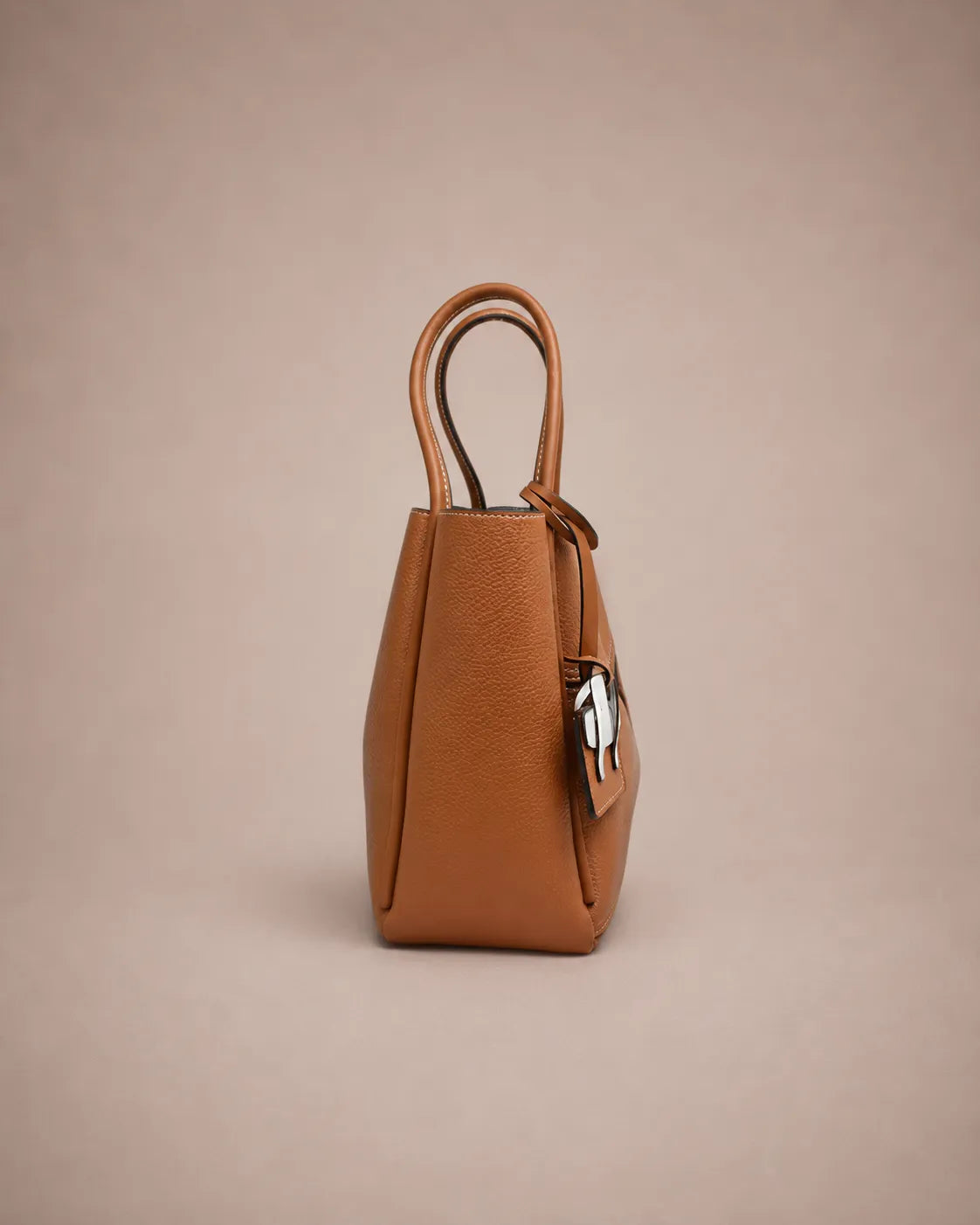 Side view of the Delphine Leather Shoulder Bag in Cookie genuine leather showcasing its structured construction, clean profile, premium craftsmanship and modern architectural shape by Malena London.
