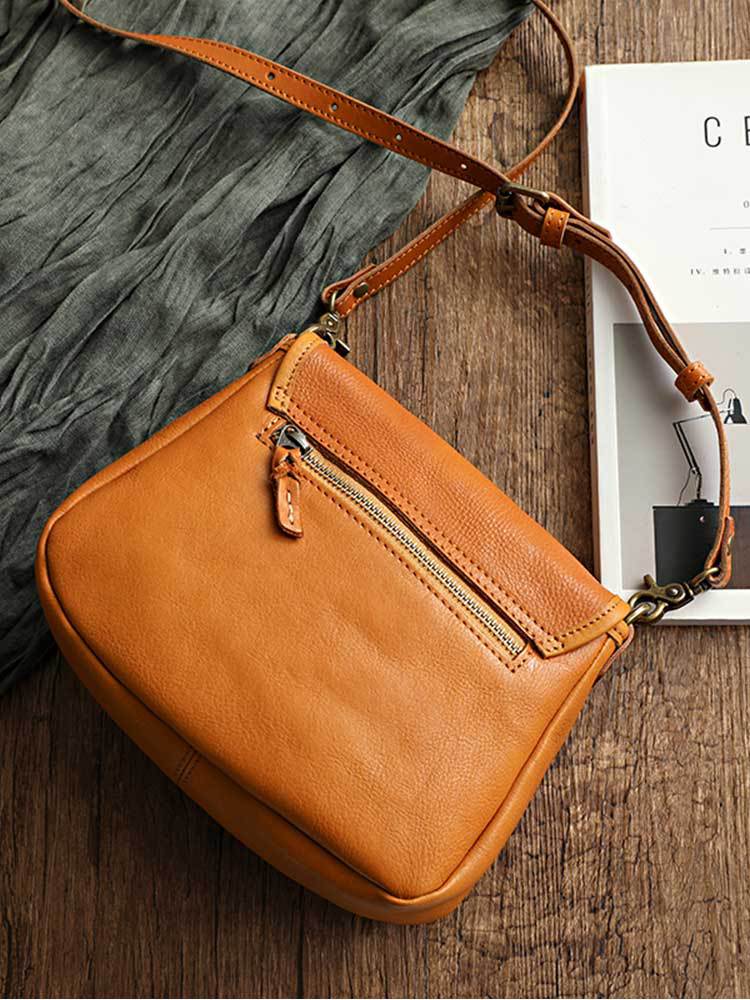 Rear view of the vintage genuine leather shoulder bag in tan showing the zipped back pocket and adjustable strap, by Malena London