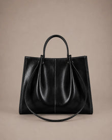 Edith Leather Tote Bag in Black genuine leather shown from the front, featuring a structured silhouette, contrast stitching and elegant top handles from The City Edit collection by Malena London.