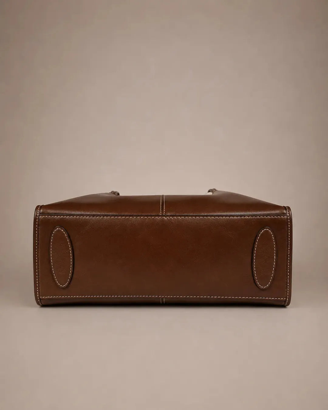 Bottom view of the Edith Leather Tote Bag in Dark Chocolate genuine leather, highlighting the structured base and premium craftsmanship from The City Edit collection by Malena London.