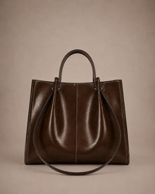 Edith Leather Tote Bag in Dark Chocolate genuine leather shown from the front, featuring a structured silhouette, contrast stitching and elegant top handles from The City Edit collection by Malena London.