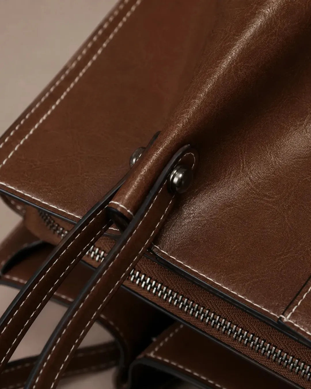Close-up detail of the Edith Leather Tote Bag in Dark Chocolate genuine leather, showcasing the premium zip closure, contrast stitching and refined craftsmanship from The City Edit collection by Malena London.