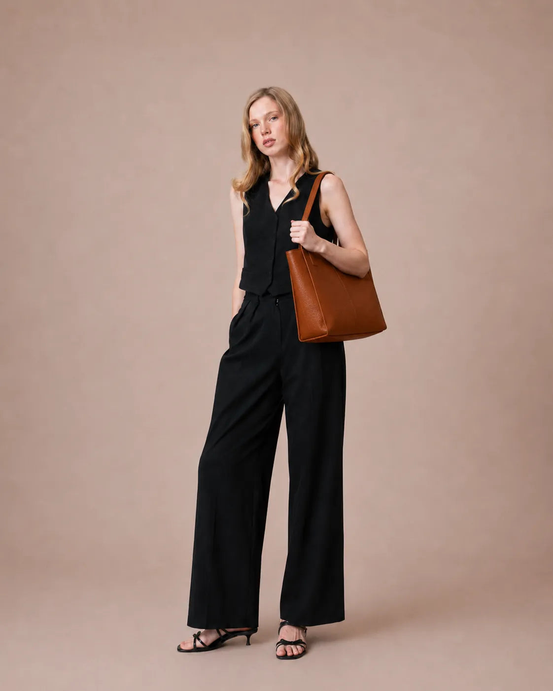 Woman wearing The Eleanor Brown leather work tote bag on the shoulder. Genuine leather tote designed for everyday organization, office essentials and modern city living.