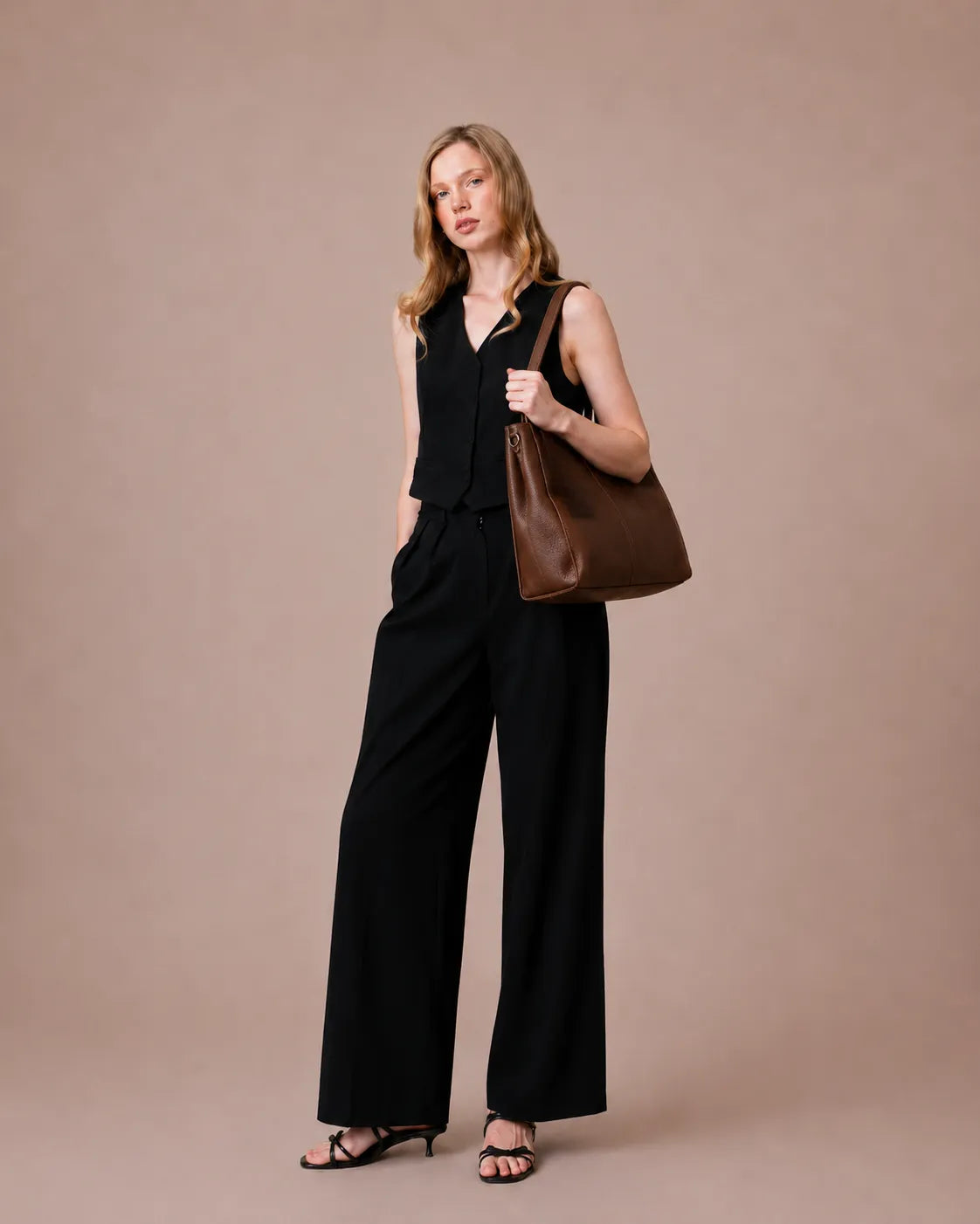 Woman wearing The Eleanor Brown leather work tote bag on the shoulder. Genuine leather tote designed for everyday organization, office essentials and modern city living.