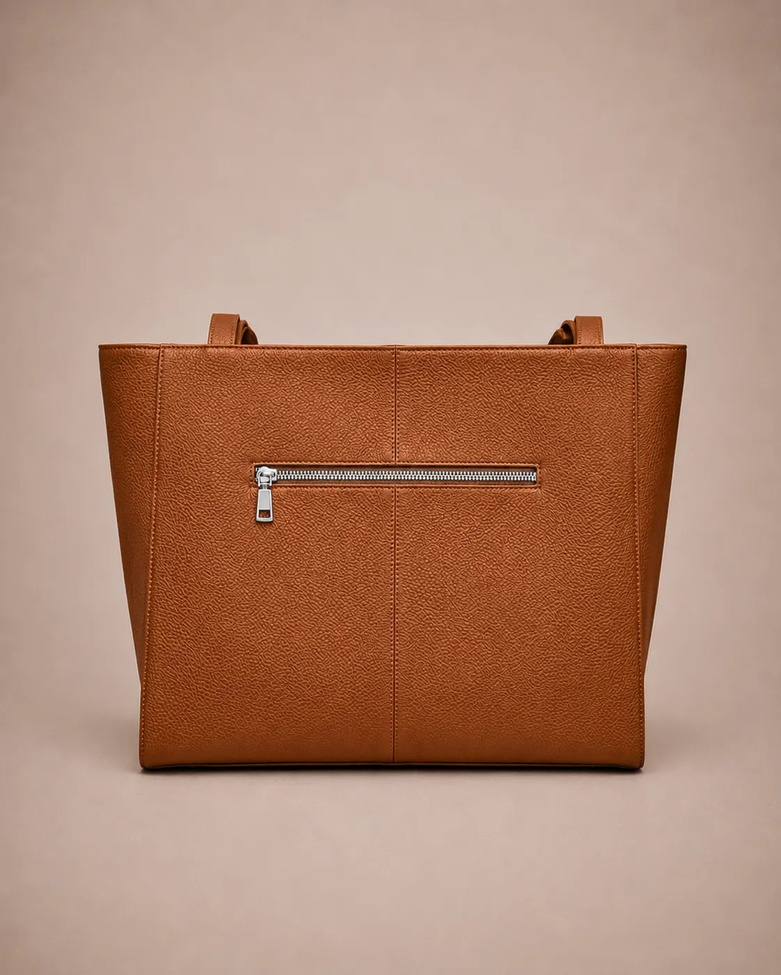 Back view of the Eleanor genuine leather tote bag in Brown featuring a clean minimalist design, exterior zip pocket and spacious structured silhouette. Elegant women's leather work tote from The City Edit collection.