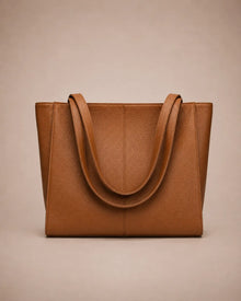 Eleanor genuine leather tote bag in Brown featuring a structured vertical silhouette, long shoulder handles, spacious interior capacity and minimalist design. Premium women's leather work bag from The City Edit collection by Malena London.