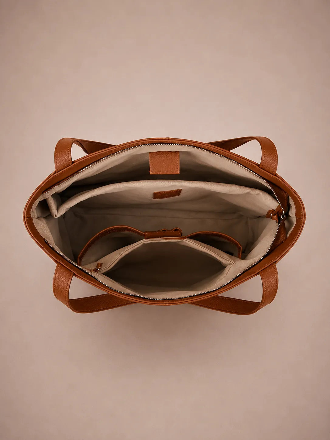 Interior view of the Eleanor genuine leather tote bag in Brown featuring a dedicated laptop compartment, document sleeve, phone pocket and spacious organised storage. Premium women's leather work tote designed for commuting and professional use.