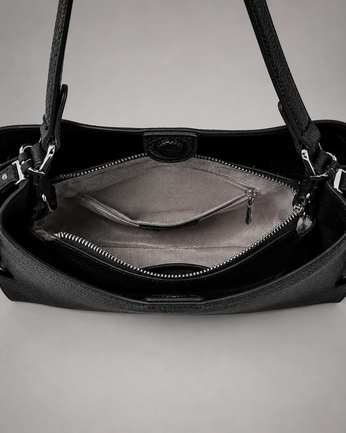 Interior view of the Eliza genuine leather shoulder bag in Black showcasing a spacious main compartment, secure zippered pocket, premium lining, organised storage sections and practical everyday functionality by Malena London.
