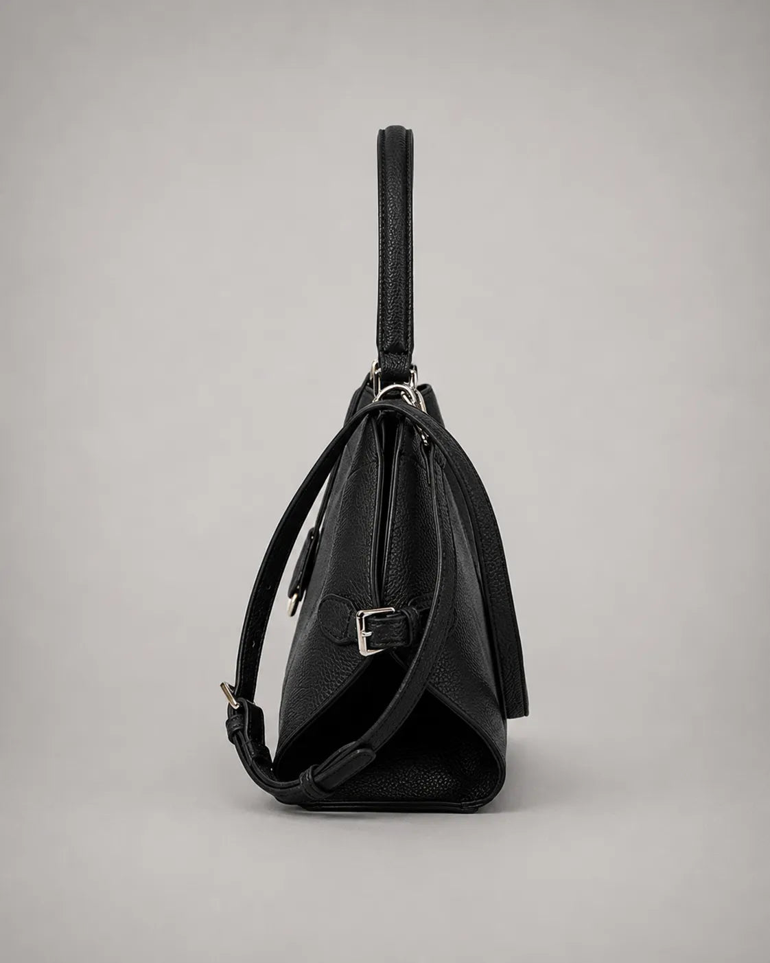 Side view of the Eliza genuine leather shoulder bag in Black highlighting the structured profile, adjustable removable strap, premium pebbled leather texture, elegant proportions and versatile day-to-evening design by Malena London.
