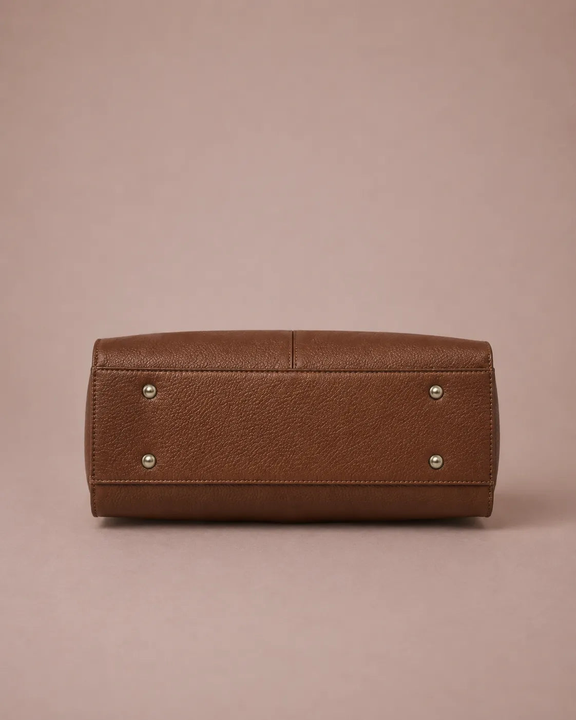 Bottom view of The Eleanor genuine leather tote bag in Brown showing the reinforced base with protective metal feet.