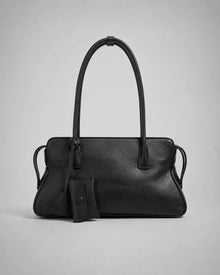 Georgia leather shoulder bag in Black genuine leather front view featuring a soft structured silhouette, double shoulder straps, decorative leather charms and secure zip-top closure from the Soft Structure collection by Malena London.