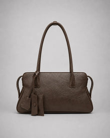 Georgia leather shoulder bag in Dark Chocolate genuine leather front view featuring a soft structured silhouette, double shoulder straps, decorative leather charms and zip-top closure from the Soft Structure collection by Malena London.