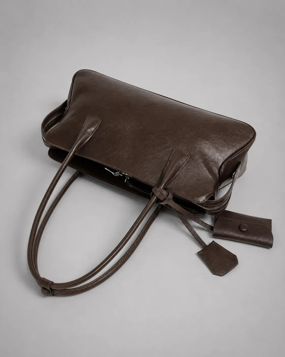 Georgia leather shoulder bag in Dark Chocolate genuine leather top view highlighting the spacious interior, zip-top opening, long shoulder straps and premium leather construction from the Soft Structure collection by Malena London.