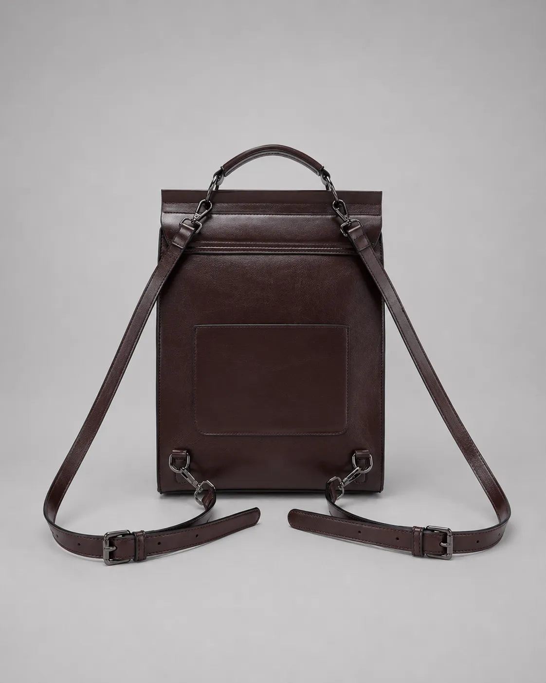 Back view of the Heritage Leather Backpack in Dark Chocolate genuine leather featuring adjustable shoulder straps, rear pocket and structured construction.