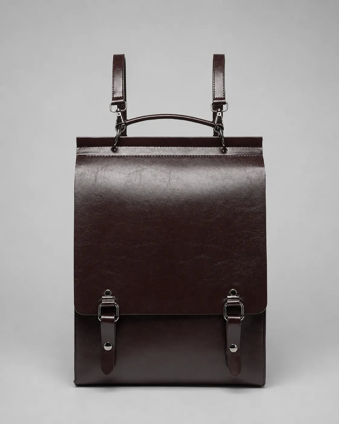 Front view of the Heritage Leather Backpack in Dark Chocolate genuine leather featuring flap closure, premium hardware and structured vintage-inspired design.