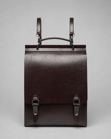 Front view of the Heritage Leather Backpack in Dark Chocolate genuine leather featuring flap closure, premium hardware and structured vintage-inspired design.