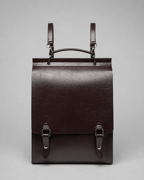 Front view of the Heritage Leather Backpack in Dark Chocolate genuine leather featuring flap closure, premium hardware and structured vintage-inspired design.