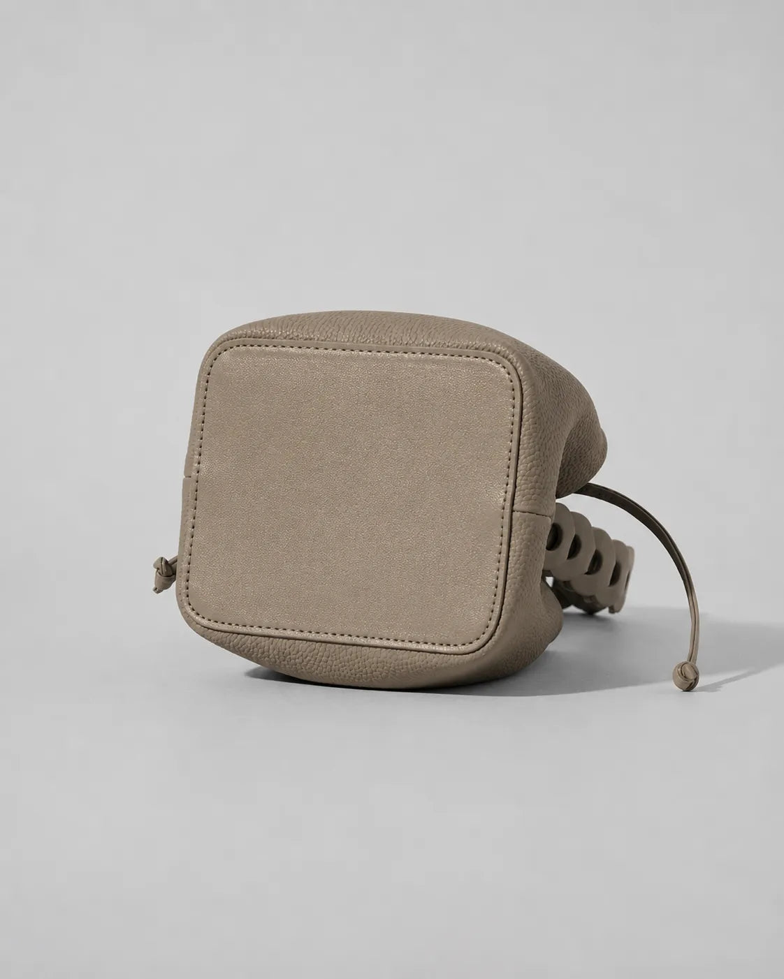 Bottom view of the Léonie genuine leather bucket bag in Cookie showing the reinforced structured base, premium leather construction and durable craftsmanship designed for everyday elegance by Malena London.